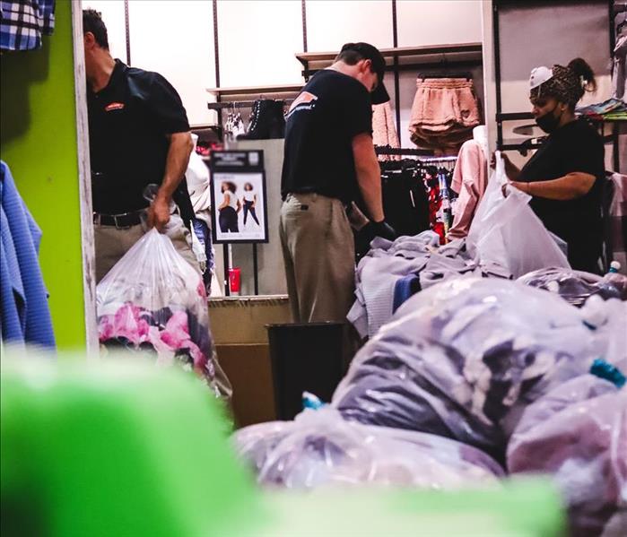 Our SERVPRO Team hard at work cleaning and disposing of fire damaged clothing in a popular clothing store
